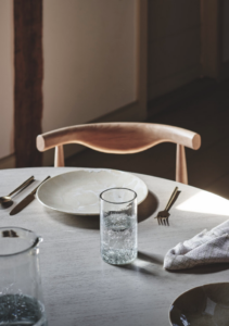 a table set with plates, glasses, and silverware