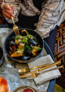 a woman eating mussels