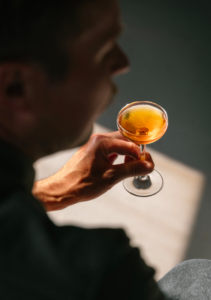 a man holding a cocktail