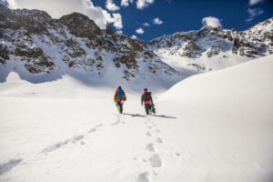 Two snowboarders walking in the snow in Aspen, Colorado