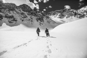 Two snowboarders walking in the snow in Aspen, Colorado