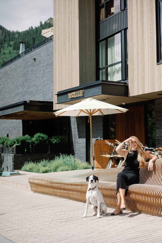 A guest sitting on the MOLLIE Powder Cloud Bench