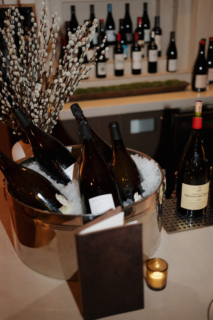 Champagne and white wine in an ice bucket at the Wine Bar at Petit Trois Aspen
