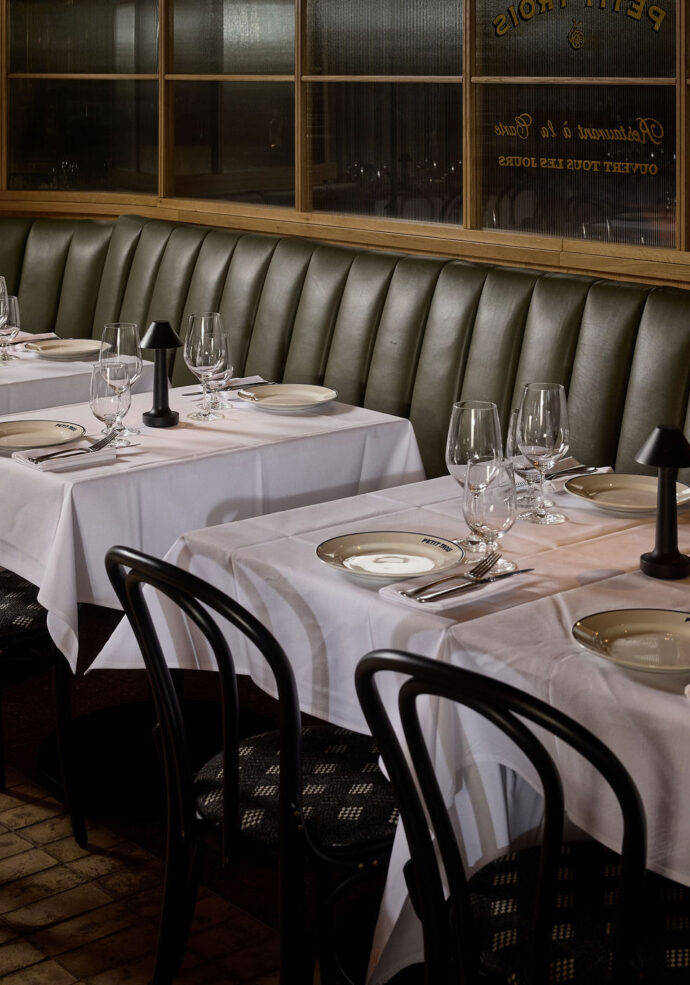 A booth set for dinner at Petit Trois Aspen