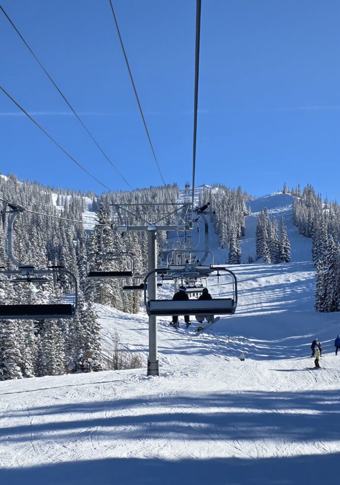 Snowy trees and the chairlift at Aspen Snowmass during the winter ski season