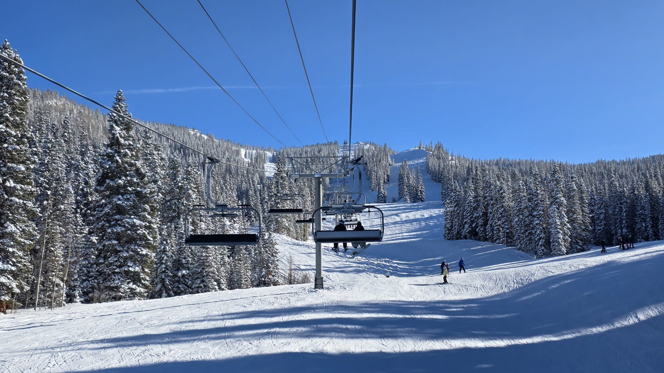 Snowy trees and the chairlift at Aspen Snowmass during the winter ski season