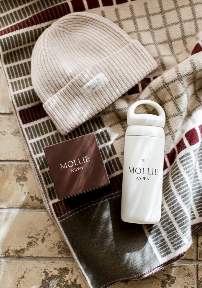Cashmere beanie, candle, water bottle and throw blanket from MOLLIE retail boutique