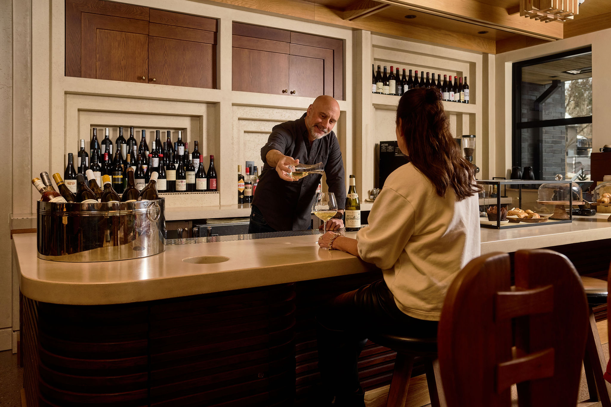 Master Sommelier Sabato Sagaria pours a glass of white wine at the Wine Bar at MOLLIE Aspen