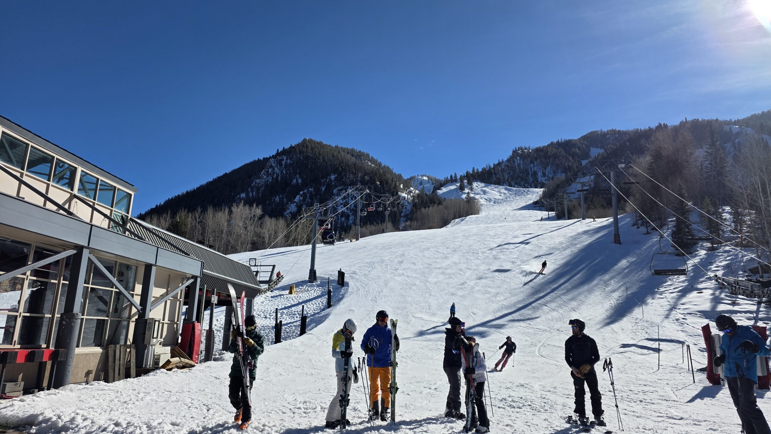 Skiers at the bottom of Ajax Mountain