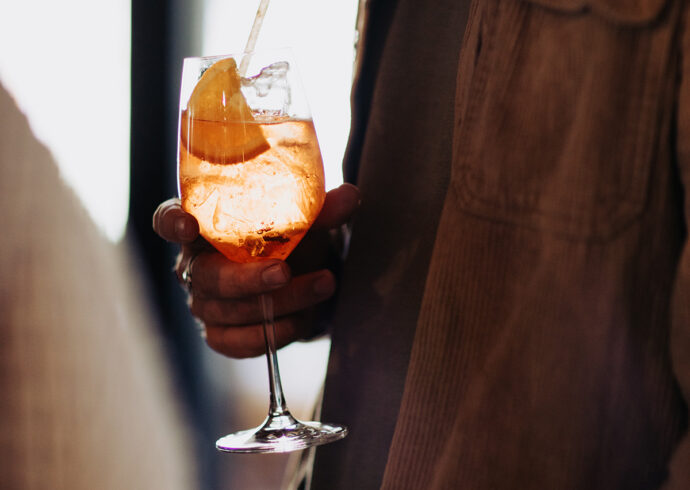a man holding a refreshing spritz drink