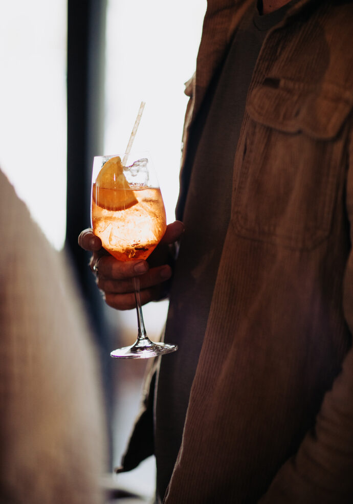a man holding a refreshing spritz drink