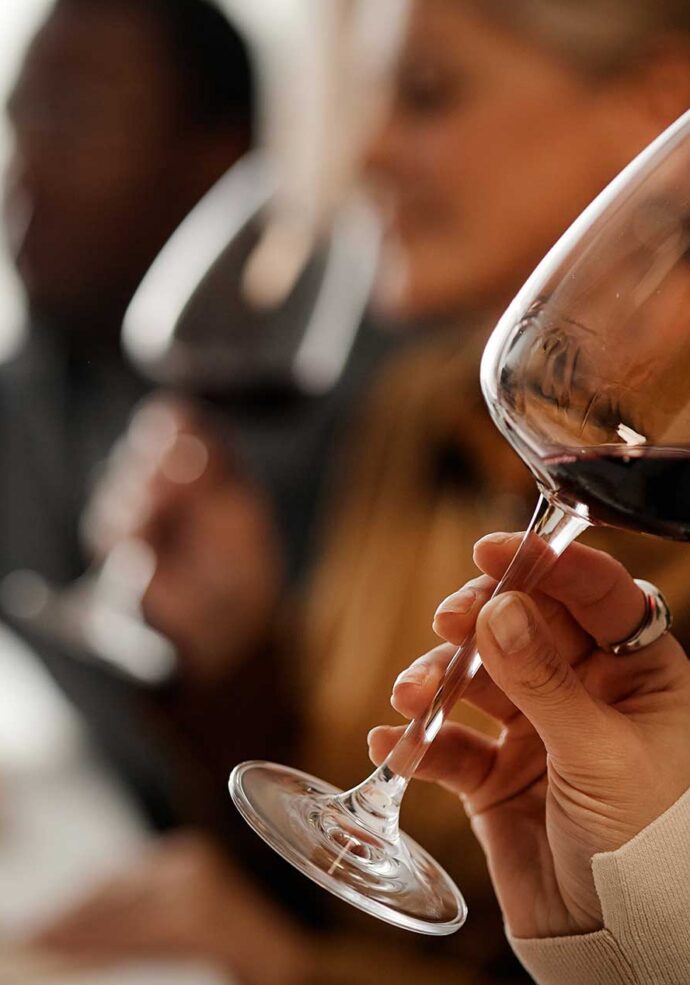 Three people at a wine tasting