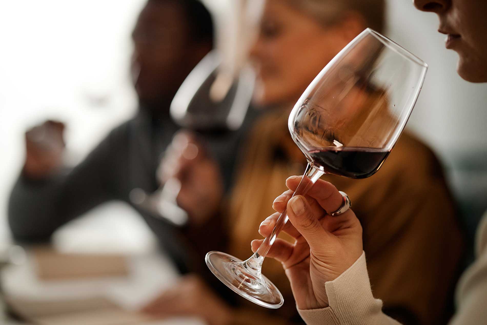 Three people at a wine tasting