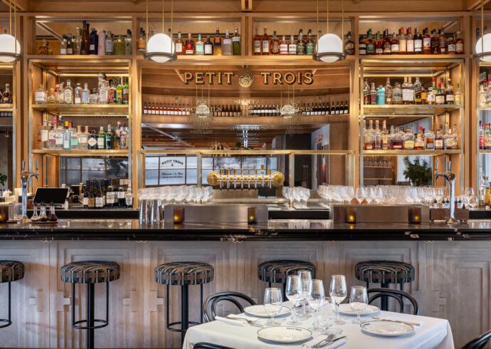 Petit Trois logo and lettering on the mirror at the bar at Petit Trois Aspen