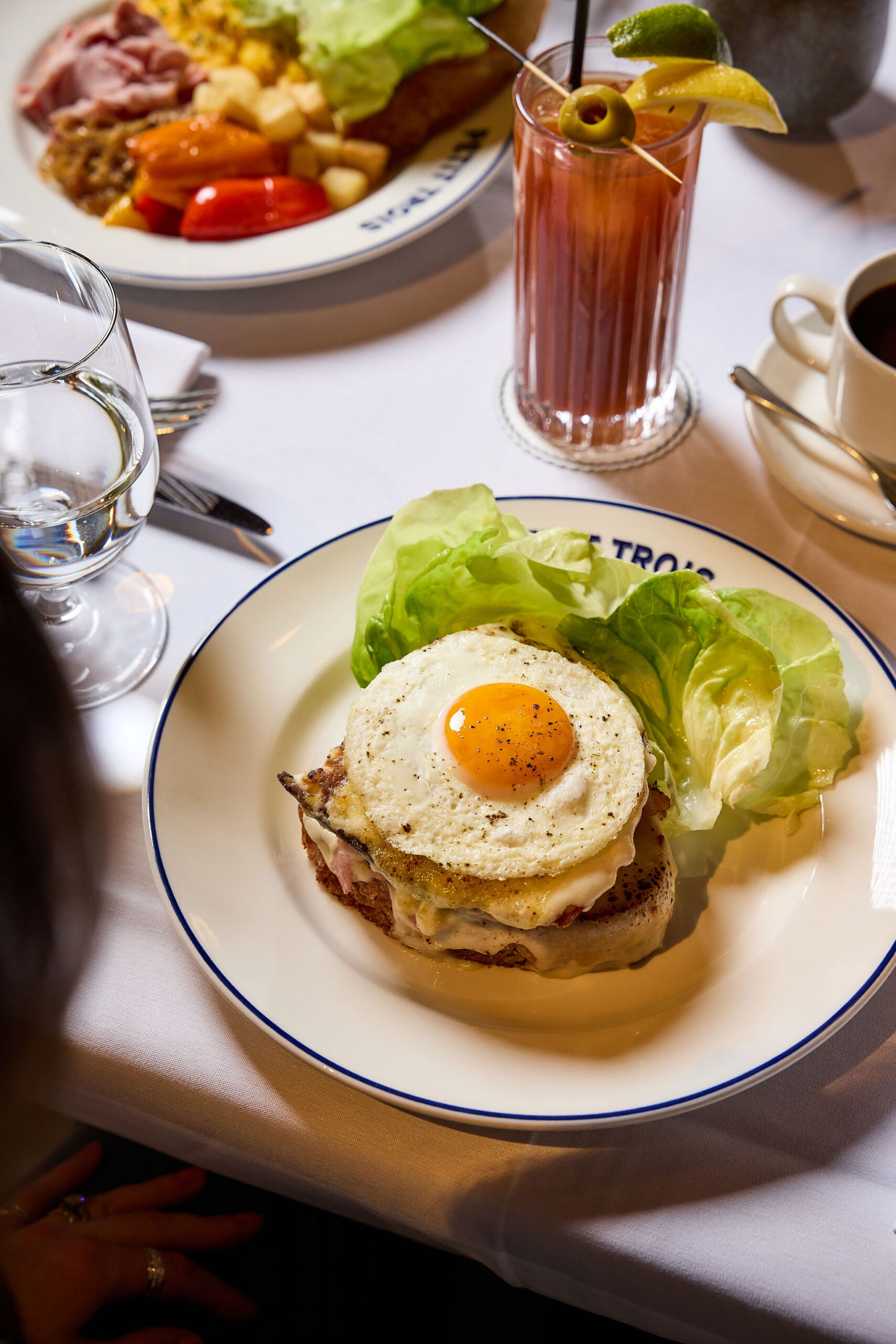 Croque Monsieur served to a guest with a bloody mary at Petit Trois Aspen