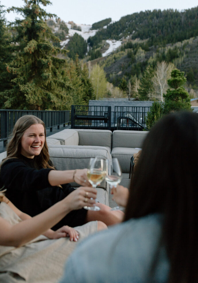 Four females guests enjoying wine on Roof Terrace at MOLLIE Aspen in Spring