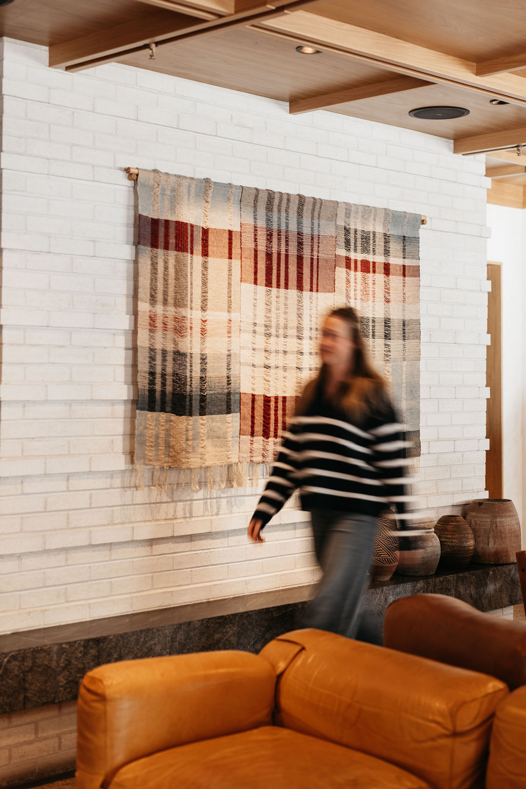 Guest walking past the woven fabric in the lounge at MOLLIE