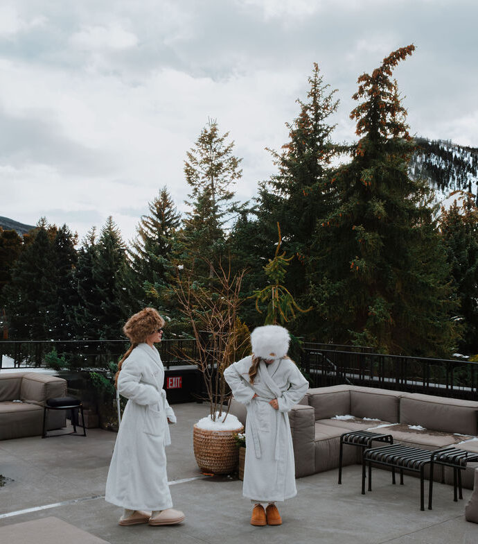 Two guests in robes on Roof Terrace in winter