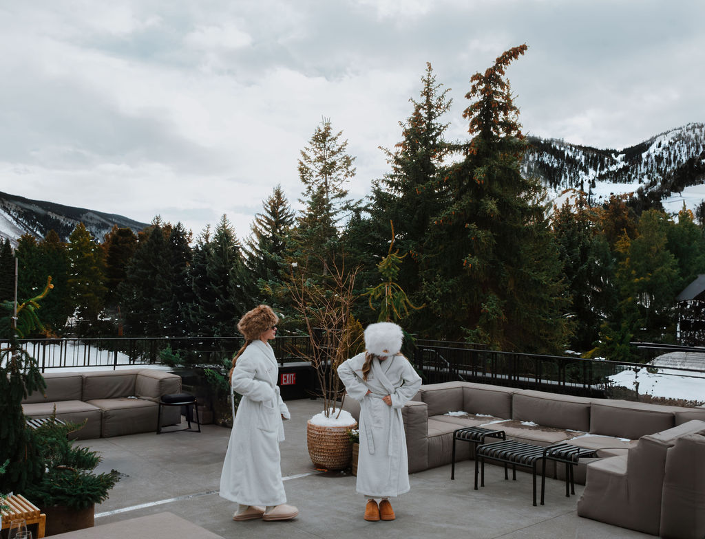 Two guests in robes on Roof Terrace in winter