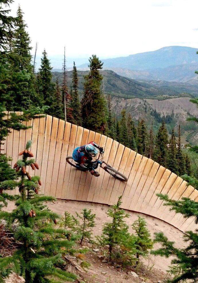 Woman downhill mountain biking at Bike Snowmass