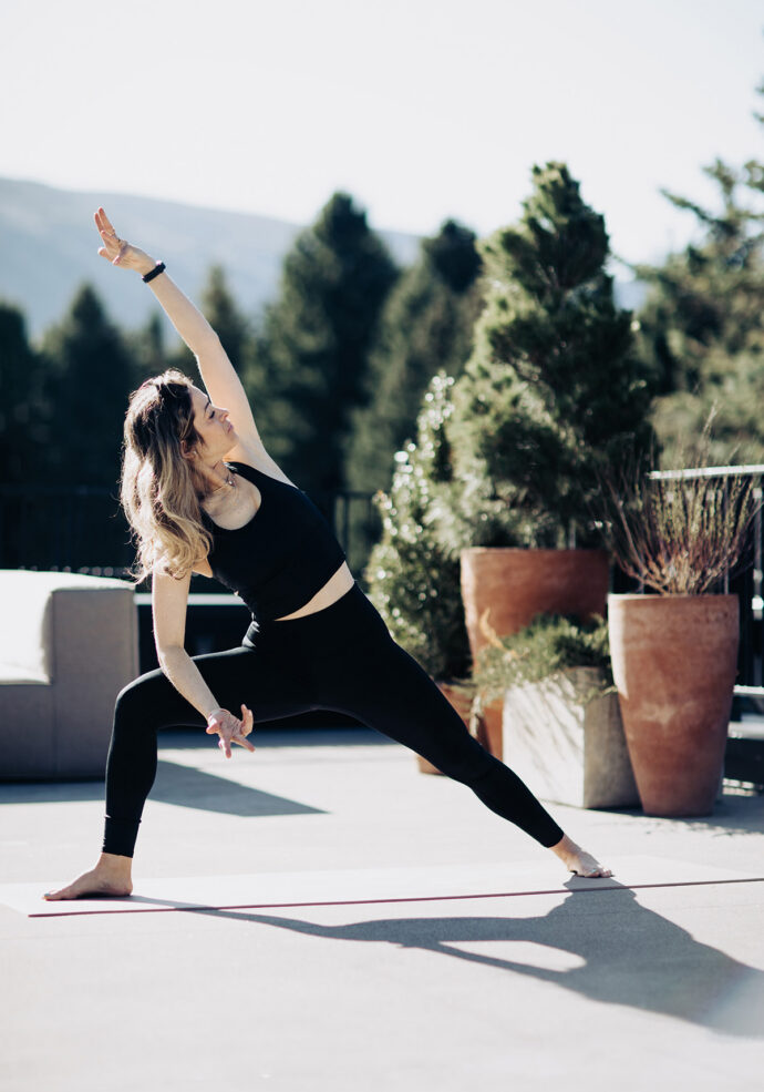 Instructor posing a yoga move on Roof Terrace