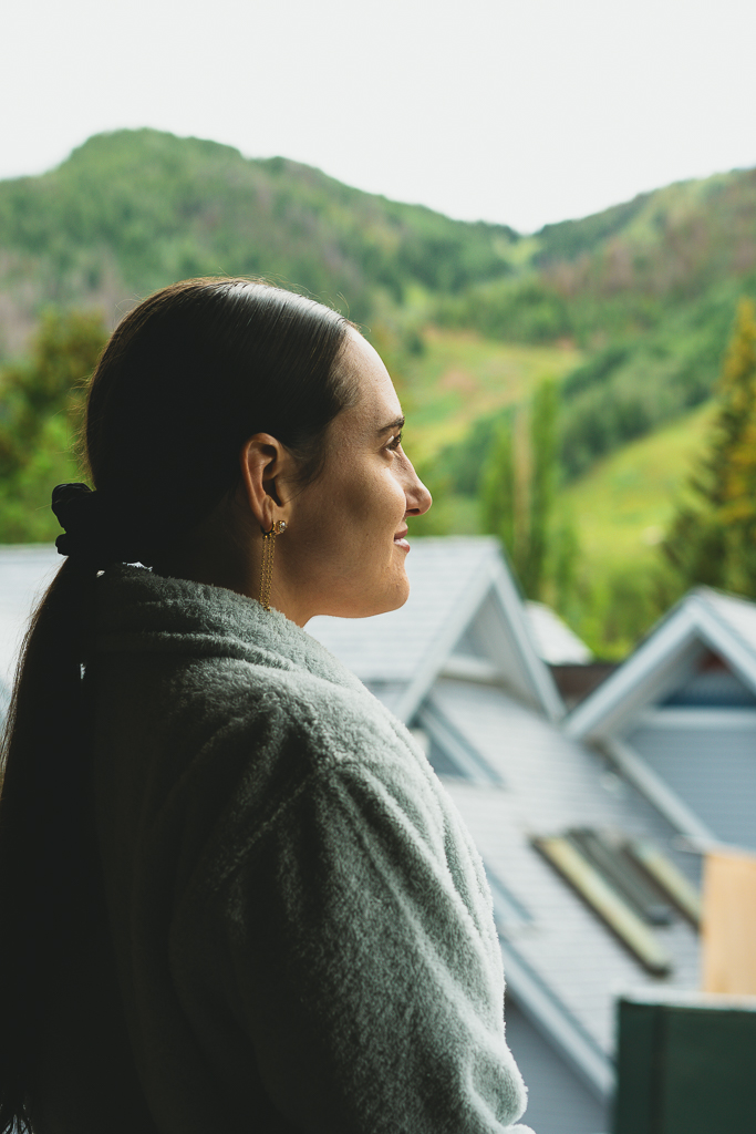 Guest looking at Ajax Mountain from the Terrace of guest room at MOLLIE Aspen