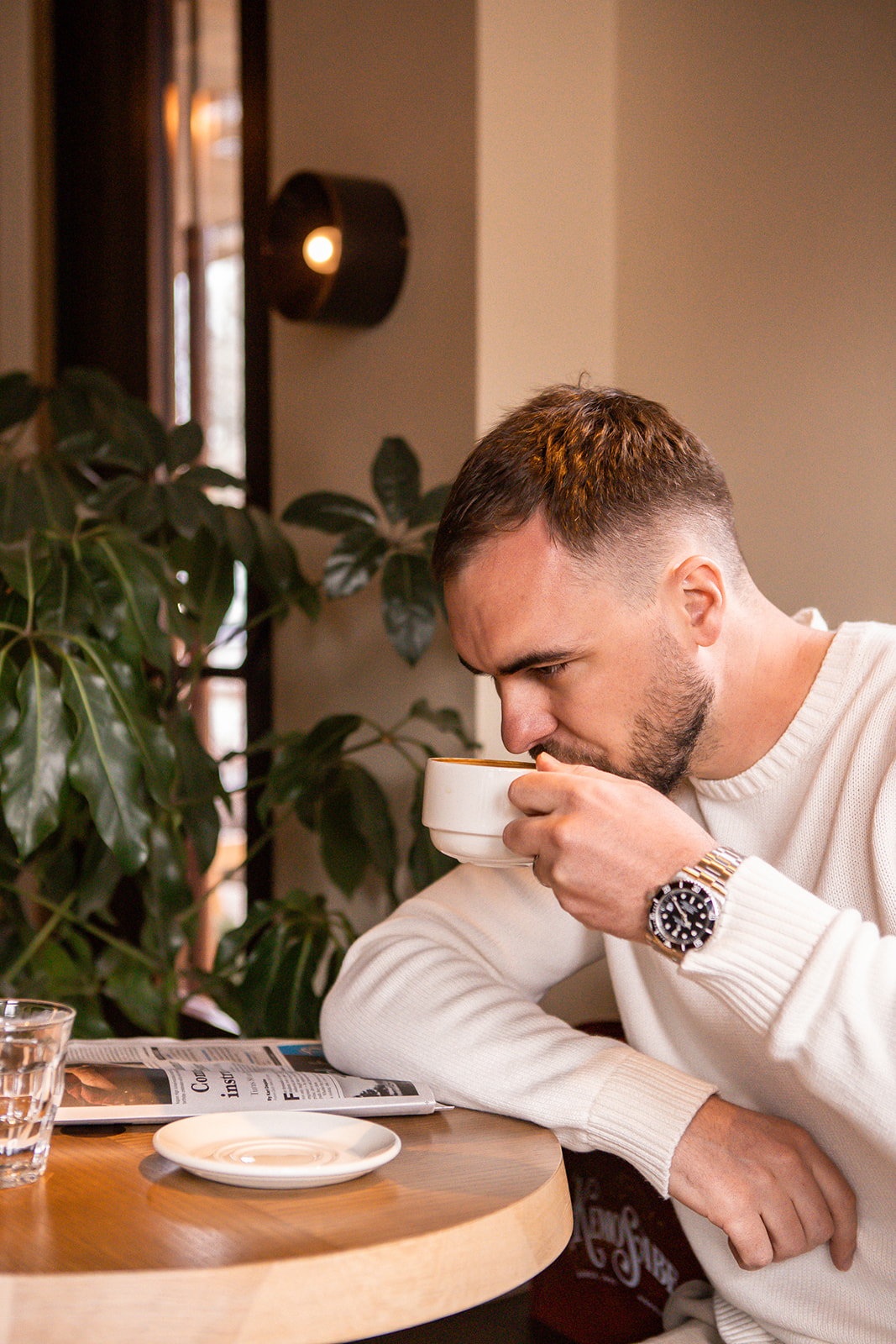 Male guest sipping on coffee at the Cafe at MOLLIE Aspen