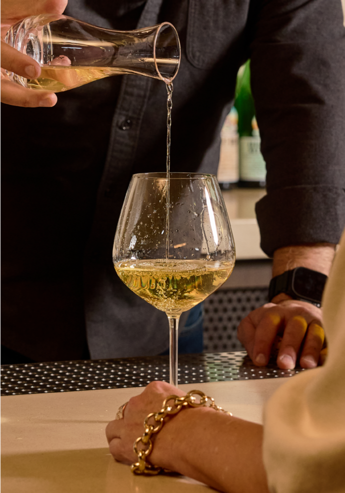 Wine being poured at Petit trois Aspen