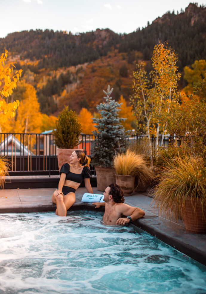 Guests in spa pool on the Roof Terrace at MOLLIE Aspen during Fall